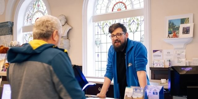 Buxton Visitor Centre inside men chatting